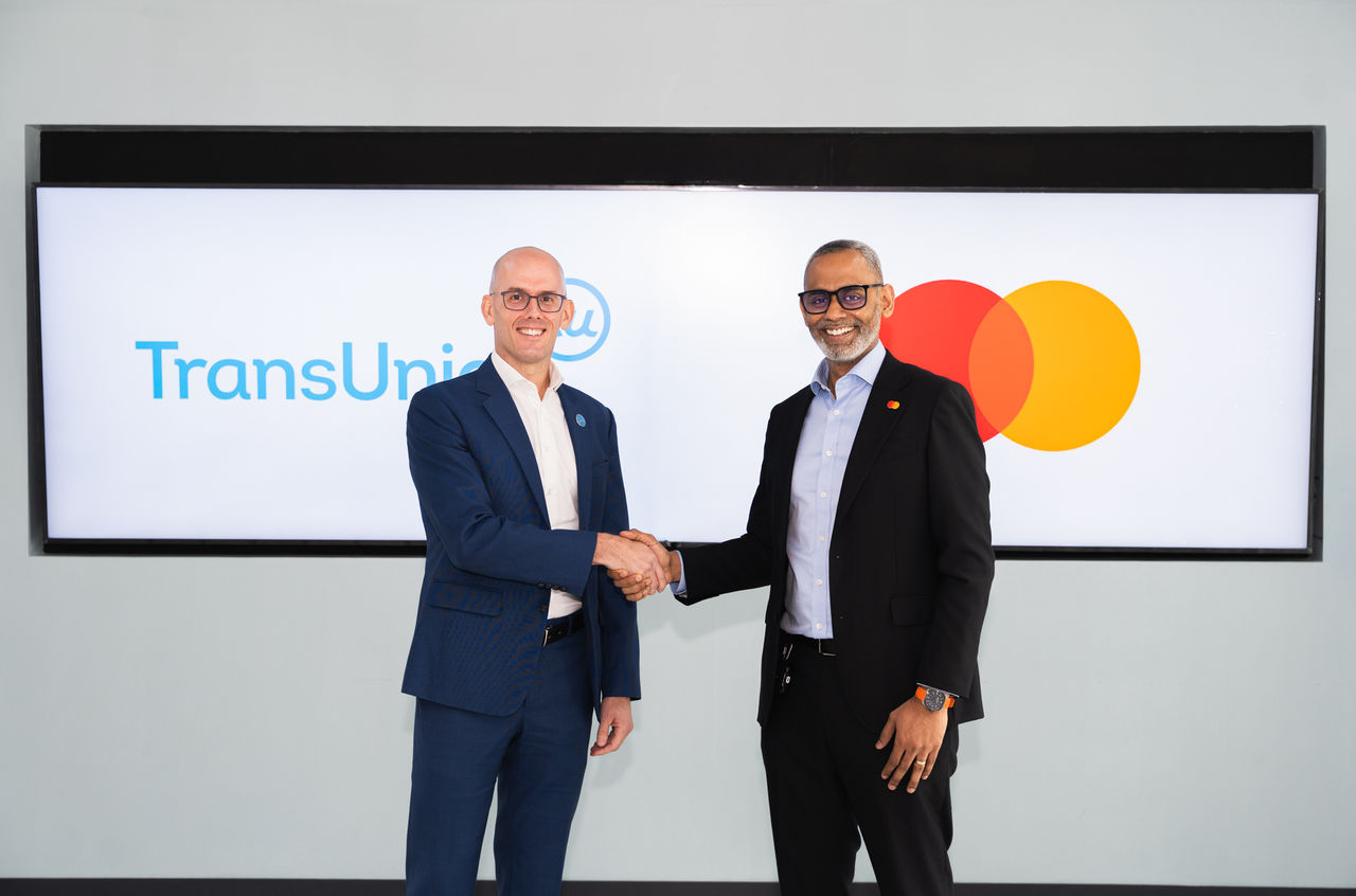 TU and Mastercard officials shaking hands